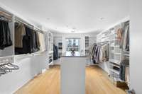 Mega walk in primary closet! A dream closet in a condo penthouse!  Island built in for even more storage!