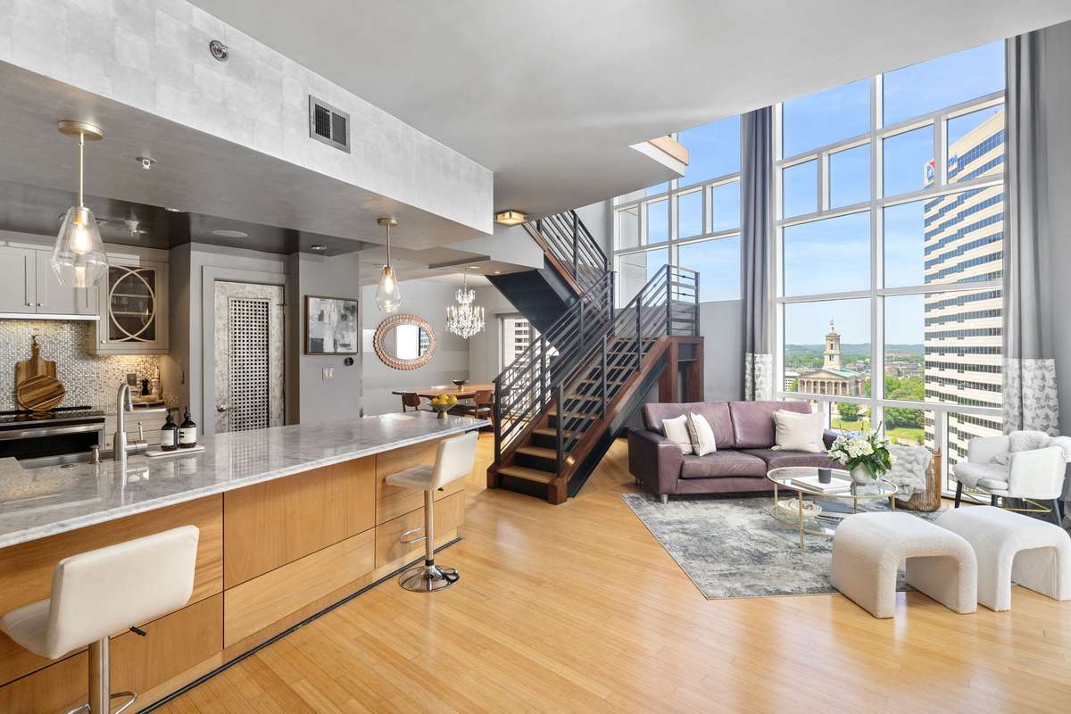 Spacious living and dining areas.  Large island.  Gorgeous details, elegant lighting, metal hand railings. Tons of natural light!
