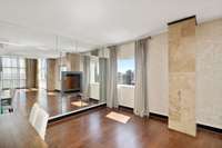 Mirrored wall and mini fireplace accent the space