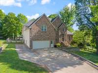 Ample driveway space offers room for extra parking—perfect for your boat, camper, or guests. EV charger in garage. Newer roof was installed by local Austermiller Roofing.