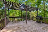 Fabulous raised deck with pergola, nestled in a peaceful fenced backyard retreat—perfect for grilling, relaxing, or entertaining under the trees.