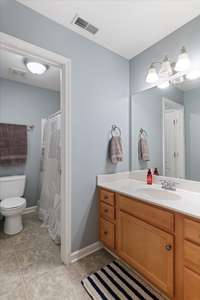 Jack-and-Jill bathroom upstairs with two private vanity areas—perfect for sharing while maintaining personal space.