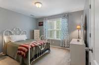 Bedroom 2 upstairs features soft natural light, a calming color palette, and a spacious walk-in closet.