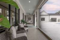 Covered patio space leading to half bath and porch swing