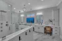 Primary Bath with heated tile floor, dual vanities and large zero entry shower