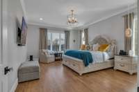 Primary bedroom with view of pool and open field
