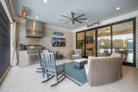Large entertaining screened and covered patio with grilling area and mounted electric heaters