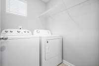 Convenient upstairs laundry room.