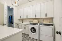 Laundry Room with Sink ample counter space, cabinets and a storage closet