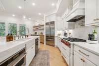 Kitchen Includes 36 inch 6 Burner Wolf Range Top, 42 Inch Subzero Refrigerator, Elkay Water Bottle Filler with Chiller and Roll out Drawers in cabinets