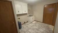 Utility room with storage closet, has access to garage and also has another door leading to the backyard
