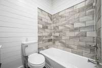 Shower / Tub combo with tile walls.