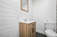 Shiplap wall covering this bathroom.