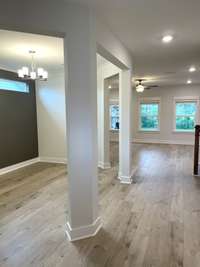 Entrance to home allows you to see the elegant formal dining area to the left and all the way to the back wall of windows in the Great Room.