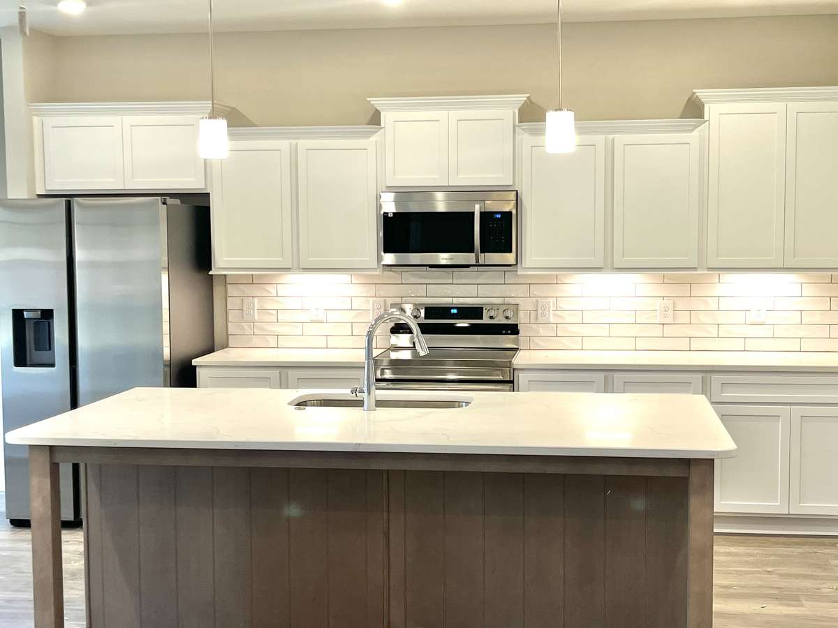 Wonderful textured backsplash highlighted by undercabinet lighting.