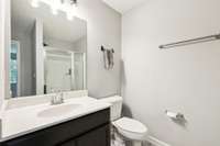 The primary bathroom includes a sleek single vanity with modern fixture above the mirror - a modern and clean look! 2336 Convention Way Murfreesboro, TN 37130