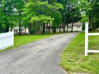 A secret retreat awaits beyond the trees — discover space, privacy, and comfort at this one-of-a-kind ranch home.
