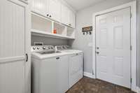 The beautiful utility room offers an abundance of neatly covered cabinet storage, perfect for keeping everything organized. Overhead cubbies provide additional storage space.1761 Center Hill Rd. Woodbury, TN 37190