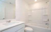 ***Photo from another townhouse recently completed in community with same finishes***  Bath #2 includes tile flooring and quartz countertops.