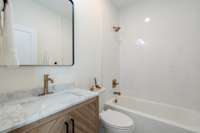 Main level bathroom next to bedroom/office.