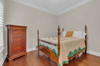 Secondary bedroom on main level with hardwood flooring