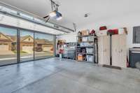 Wonderful garage space that has a pull down screen allowing you to have plenty of natural light in to work on your favorite projects