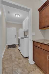 Awesome laundry room on main level with built in cabinets!  New washer & dryer remain!