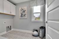 Laundry room upstairs near bedrooms for convenience.