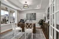 Study with glass French doors off of the foyer entry.
