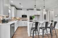 Chef's kitchen including 42" upper cabinets, SS appliances, granite or quartz countertops, and tile backsplash.
