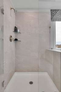Primary suite bathroom features double vanities, tile flooring, and choice of tiled shower or tiled shower and garden tub at NO cost!