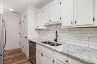 Updated cabinets with new sink, faucet and dishwasher