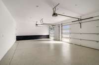 3 car garage with epoxy floor and there is also an additional storage room