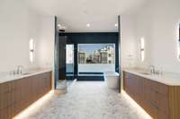 One floor down, primary bath highlights the owners level