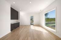 2nd floor lounge / rec room with wet bar and covered large deck