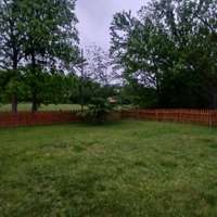 Fenced in area of back area for the pets and/or children