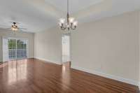 Living room/dining room with a lot of natural light.