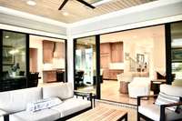 Upgraded sliding glass doors open to dining room and living room