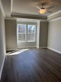 Primary bedroom looking out to the wooded area behind.