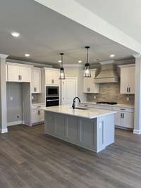 This kitchen has it all- lots of cabinets, gas cooktop, wall oven, wall microwave, venting over the cooktop to outside, and the pantry is walk in.