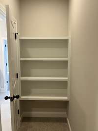 Trim built linen stack in primary closet.