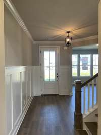 The Foyer is spacious and includes crown molding and wall detail.