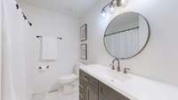 FULL BATHROOM WITH NEW TILE, VANITY, TOILET AND ACCESORIES.