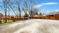 SPACIOUS PARKING TO ACCOMODATE MANY VEHICLES.  THERE IS A CARPORT AND A SHED.