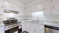 FRESHLY PAINTED CABINETS WITH NEW HARWARE.