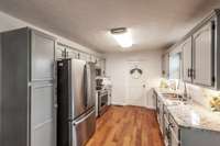 Granite countertops, updated hardware and ceiling paint