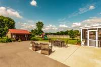 Large concrete patio and screened in porch