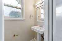 Half bath off one of the back bedrooms (originally the primary bedroom when house was built)