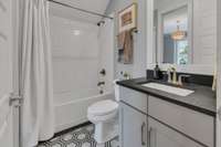 Downstairs bathroom serves as a powder room and walks through to the guest room/office.