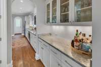 Butler's pantry includes more cabinetry, storage and space for the coffee maker or dry bar.